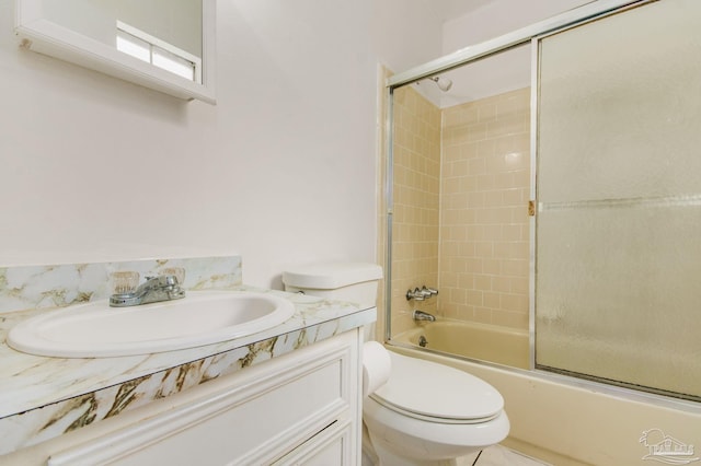 full bathroom with vanity, toilet, and enclosed tub / shower combo