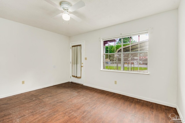 unfurnished room featuring ceiling fan and dark hardwood / wood-style flooring