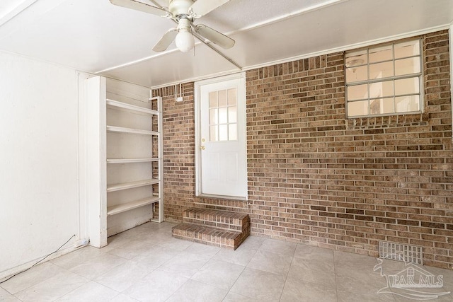 entrance to property with ceiling fan