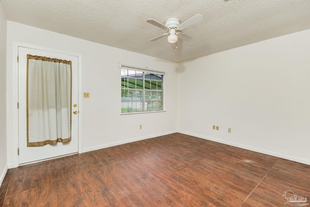 spare room with ceiling fan, dark hardwood / wood-style flooring, and a textured ceiling