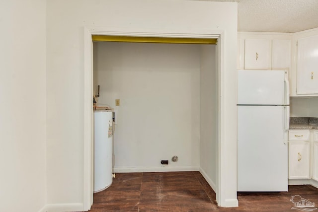 laundry room with a textured ceiling, dark hardwood / wood-style floors, and water heater