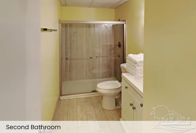 999 Ft Pickens Rd Unit 108, Pensacola Beach, FL 32561 - bathroom featuring a shower stall, toilet, wood finished floors, and vanity