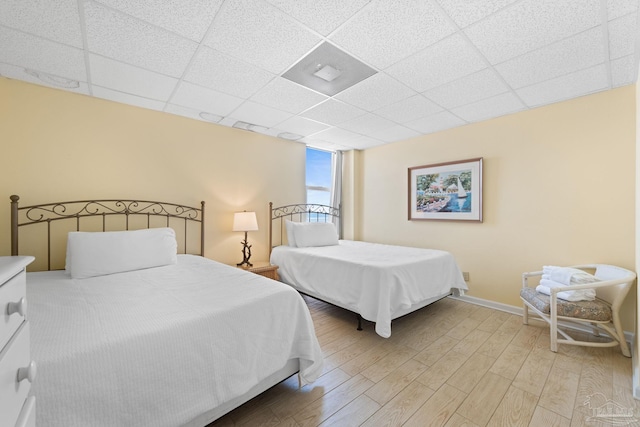 999 Ft Pickens Rd Unit 108, Pensacola Beach, FL 32561 - bedroom featuring light wood finished floors, baseboards, and a drop ceiling