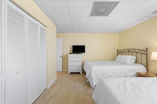 999 Ft Pickens Rd Unit 108, Pensacola Beach, FL 32561 - bedroom with light wood finished floors, a paneled ceiling, a closet, and baseboards