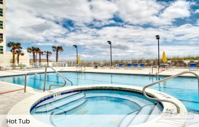999 Ft Pickens Rd Unit 108, Pensacola Beach, FL 32561 - community pool with fence, a community hot tub, and a patio area