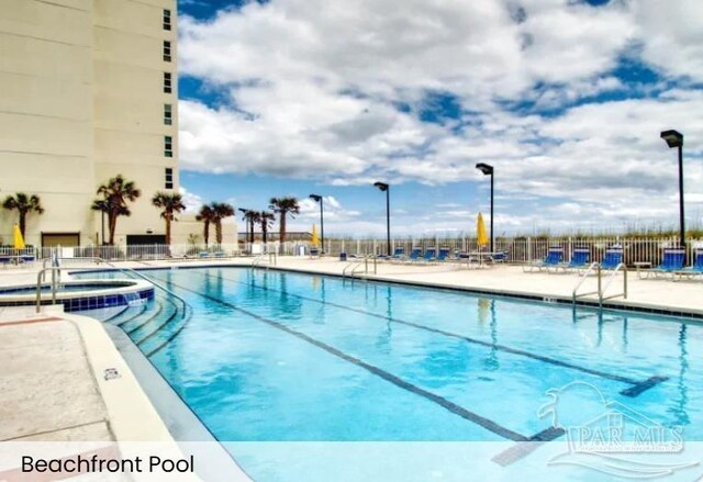 999 Ft Pickens Rd Unit 108, Pensacola Beach, FL 32561 - community pool featuring fence, a patio area, and a community hot tub