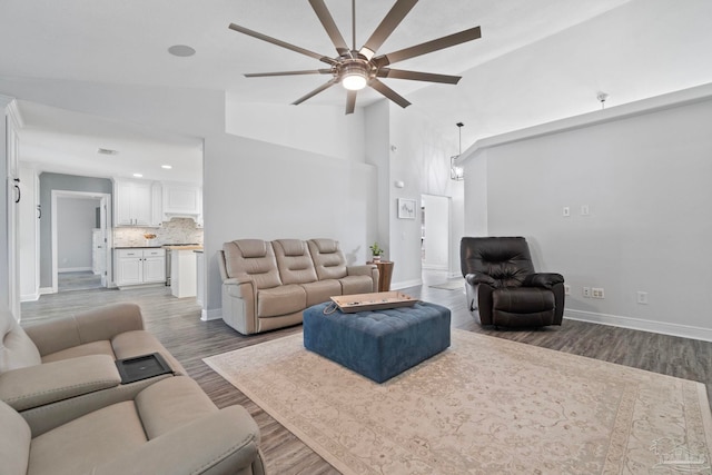 living room featuring hardwood / wood-style flooring, high vaulted ceiling, and ceiling fan