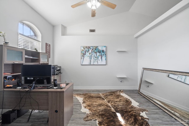 office space featuring ceiling fan, dark hardwood / wood-style flooring, and vaulted ceiling