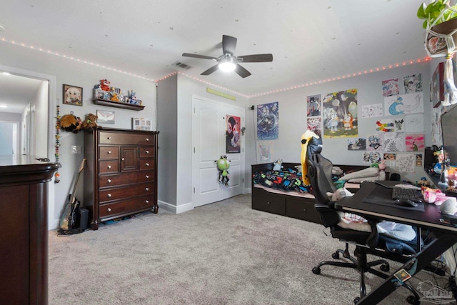 office space featuring ceiling fan and light colored carpet