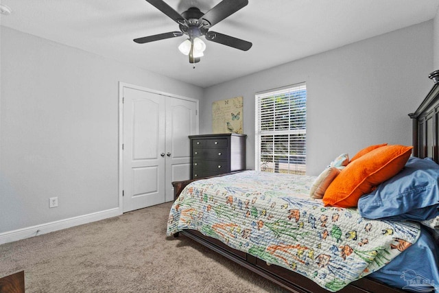 carpeted bedroom featuring ceiling fan and a closet