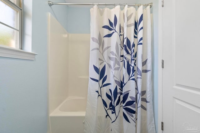 bathroom featuring shower / bath combo with shower curtain