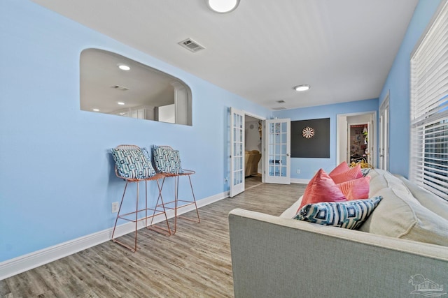 living room featuring french doors and hardwood / wood-style flooring