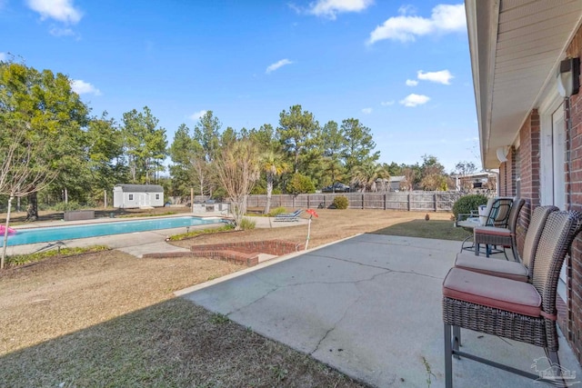 view of patio / terrace with a fenced in pool and an outdoor structure