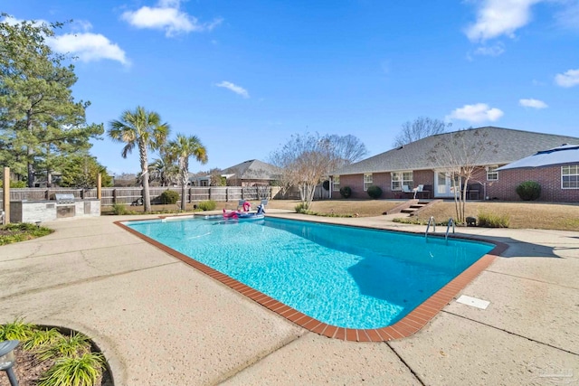 view of pool with a patio area and exterior kitchen