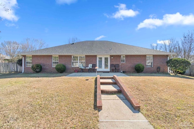 view of front of property with french doors, a patio, and a front yard