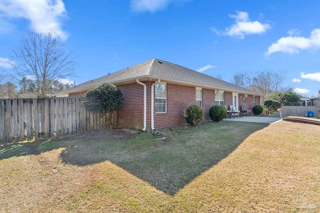 view of home's exterior featuring a lawn and a patio area