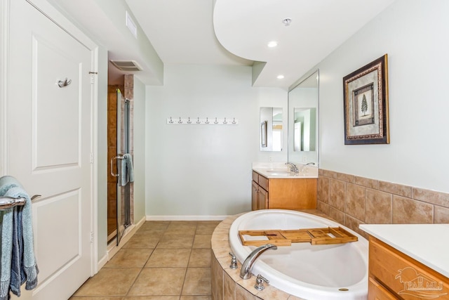 bathroom with tile patterned flooring, shower with separate bathtub, and vanity