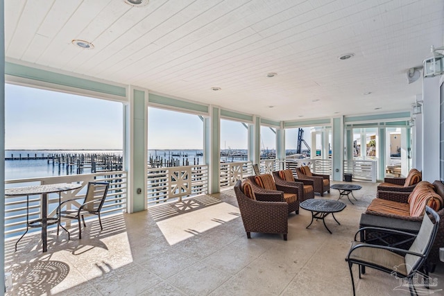 sunroom / solarium featuring a water view