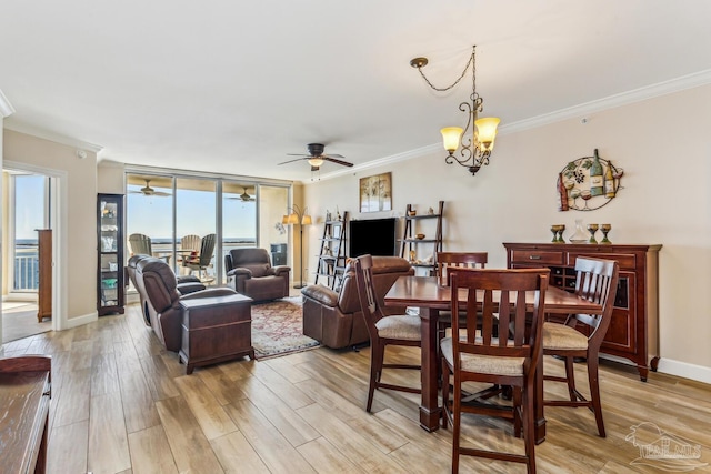 dining room featuring ornamental molding, light hardwood / wood-style floors, an inviting chandelier, and a healthy amount of sunlight