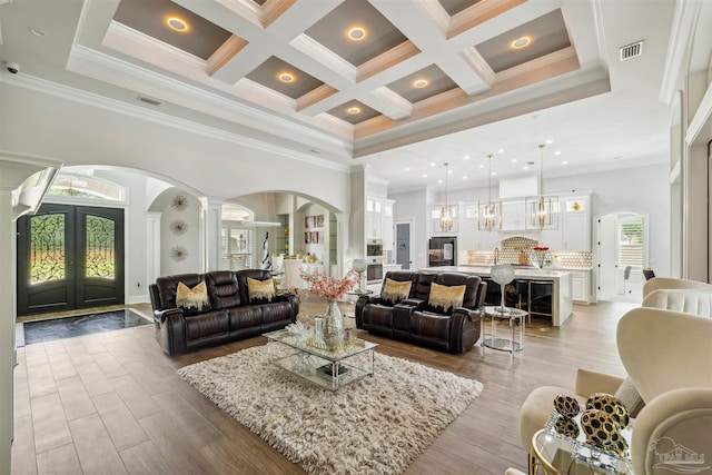 6126 E Fence Rd, Pensacola, FL 32526 - living room featuring arched walkways, a high ceiling, decorative columns, coffered ceiling, and beamed ceiling