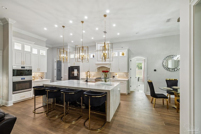 6126 E Fence Rd, Pensacola, FL 32526 - kitchen with a spacious island, recessed lighting, decorative backsplash, white cabinetry, and double oven