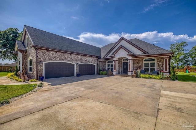 6126 E Fence Rd, Pensacola, FL 32526 - view of front facade featuring an attached garage, driveway, brick siding, and a shingled roof