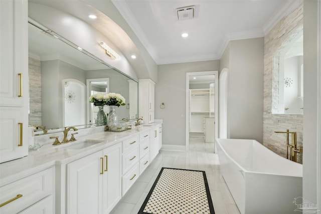 6126 E Fence Rd, Pensacola, FL 32526 - full bathroom with double vanity, a soaking tub, a spacious closet, crown molding, and recessed lighting