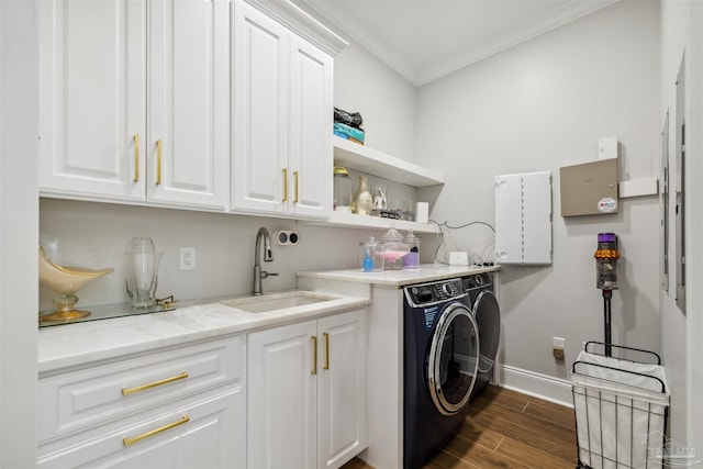 6126 E Fence Rd, Pensacola, FL 32526 - laundry room featuring independent washer and dryer, cabinet space, ornamental molding, and dark wood finished floors