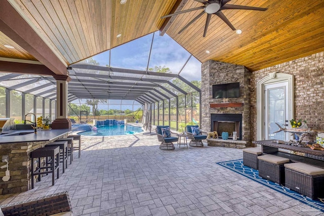 6126 E Fence Rd, Pensacola, FL 32526 - view of patio featuring an outdoor stone fireplace, an outdoor pool, a lanai, and ceiling fan