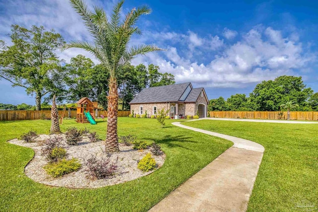 6126 E Fence Rd, Pensacola, FL 32526 - fenced backyard featuring a playground and an attached garage