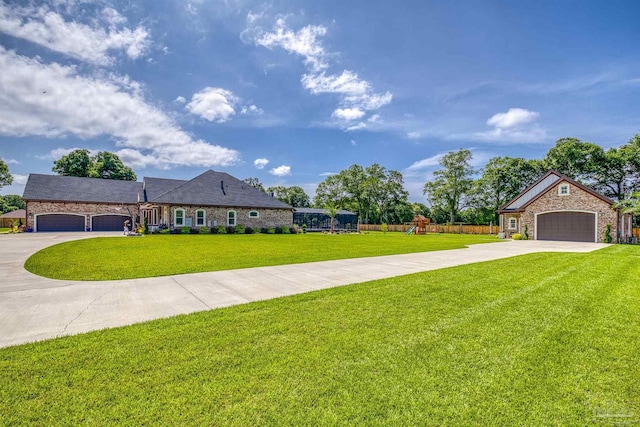 6126 E Fence Rd, Pensacola, FL 32526 - view of front of property with driveway, an attached garage, stone siding, and a playground
