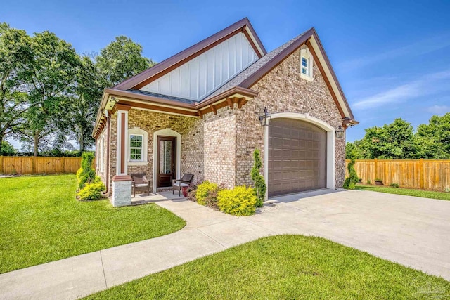 6126 E Fence Rd, Pensacola, FL 32526 - view of front of house with concrete driveway, board and batten siding, brick siding, and a garage