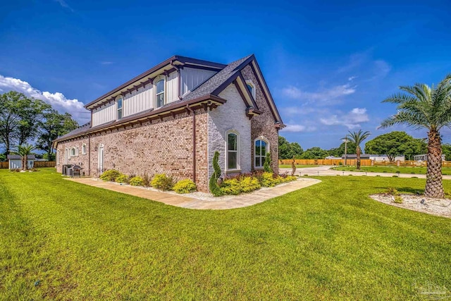 6126 E Fence Rd, Pensacola, FL 32526 - view of home's exterior featuring a lawn and brick siding