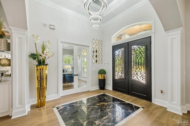 6126 E Fence Rd, Pensacola, FL 32526 - entrance foyer featuring french doors, wood finished floors, ornamental molding, and a chandelier