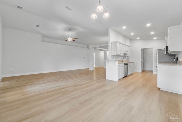 kitchen featuring ceiling fan, appliances with stainless steel finishes, light hardwood / wood-style flooring, and white cabinets