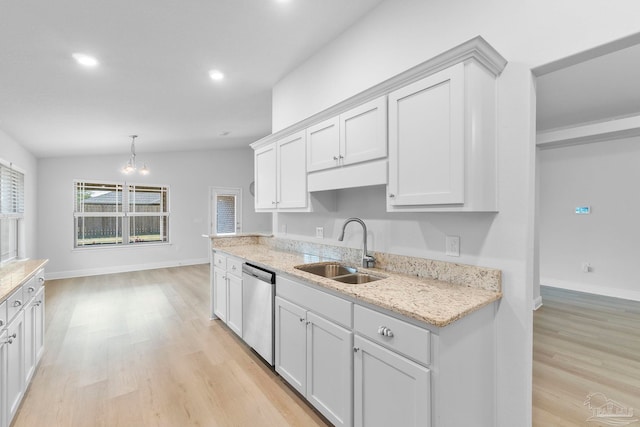 kitchen featuring sink, light wood-type flooring, light stone counters, stainless steel dishwasher, and white cabinets