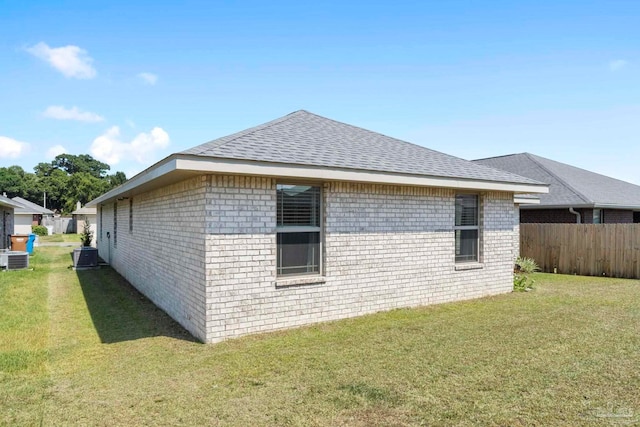 view of home's exterior with a lawn and cooling unit