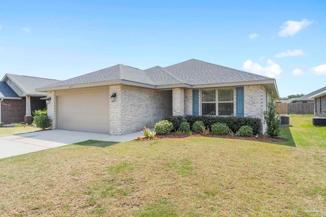 view of front of home with a garage, a front lawn, and central AC