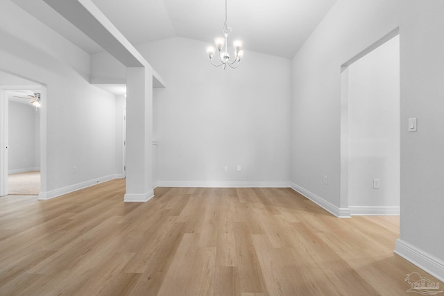 unfurnished room featuring light wood-type flooring, vaulted ceiling, and ceiling fan with notable chandelier