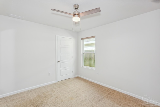 carpeted empty room featuring ceiling fan