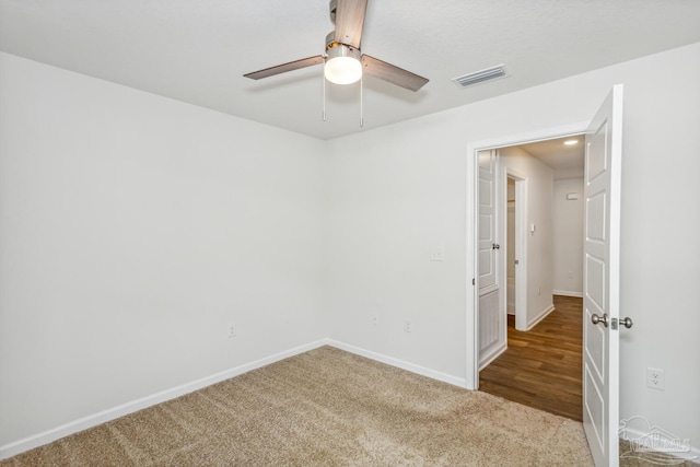 carpeted spare room featuring ceiling fan