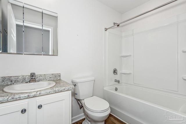 full bathroom with hardwood / wood-style flooring, vanity, toilet, and shower / bath combination