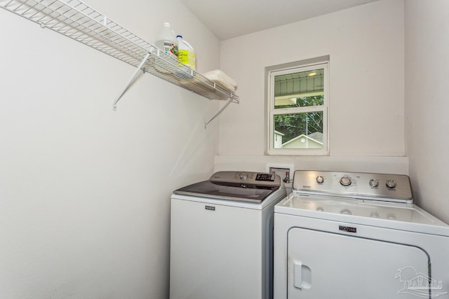 clothes washing area with washing machine and dryer