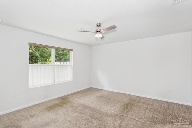 spare room featuring carpet flooring and ceiling fan