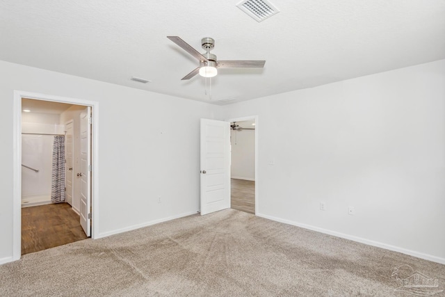 carpeted spare room with ceiling fan