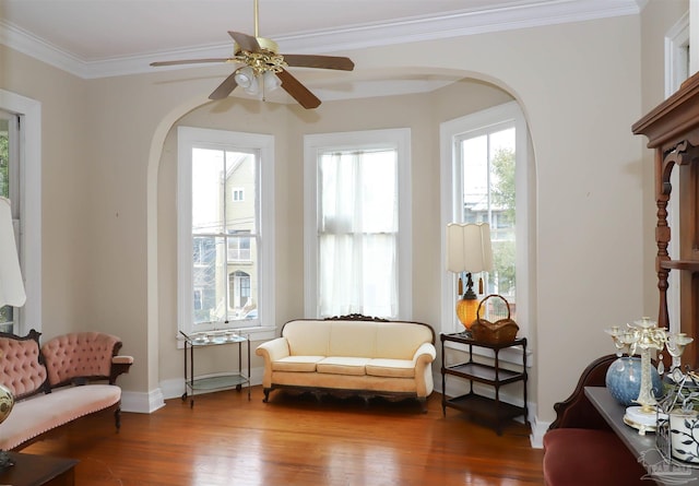 sitting room featuring crown molding, hardwood / wood-style flooring, and ceiling fan