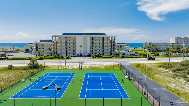 view of tennis court featuring a water view