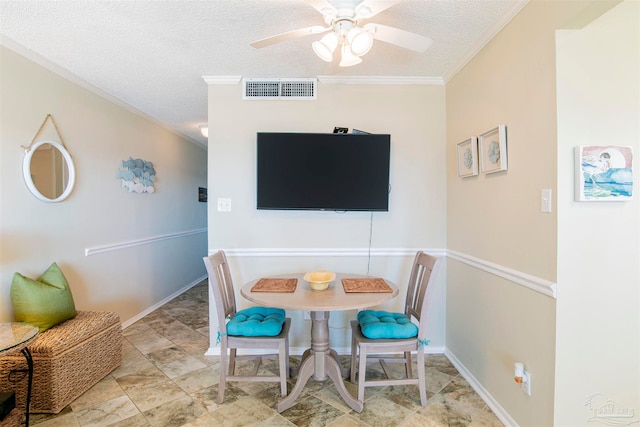 dining room featuring ornamental molding, a textured ceiling, light tile patterned floors, and ceiling fan