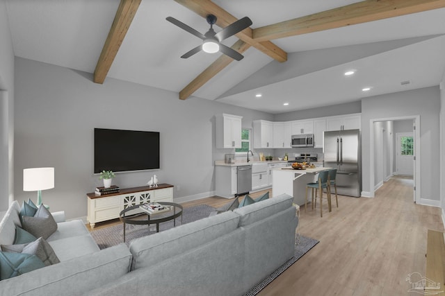 living area with recessed lighting, baseboards, lofted ceiling with beams, and light wood-style floors