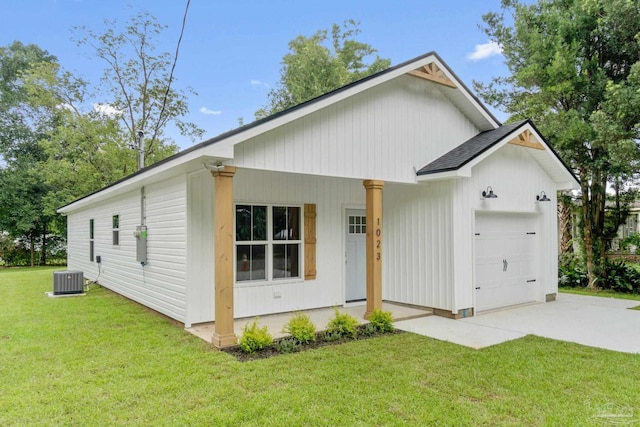 modern farmhouse featuring a front yard, cooling unit, roof with shingles, concrete driveway, and a garage